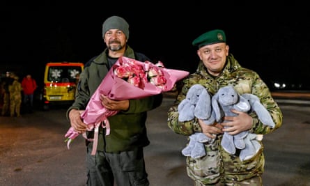 Ukrainian servicemen prepare to meet the women released from Russian captivity on Monday.