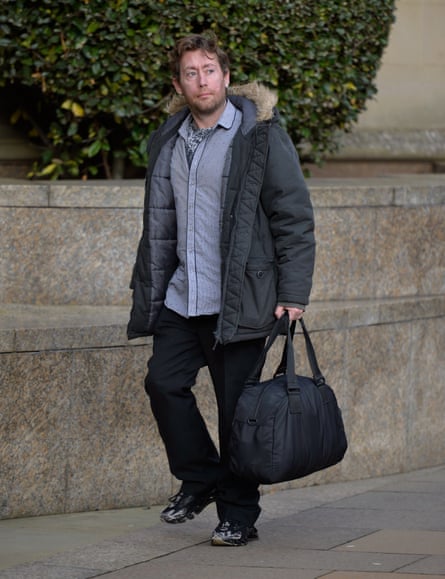 Lee Milne walking outside wearing a coat and carrying a duffle bag