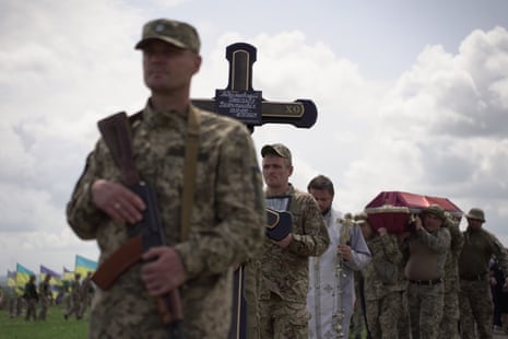Soldiers of Ukraine’s 92nd brigade walk in a funeral procession in Novoselivka, Kharkiv.
