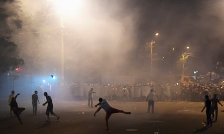 Demonstrators who had gathered in show of support for gunmen holding several hostages in police station, clash with riot police in Yerevan.