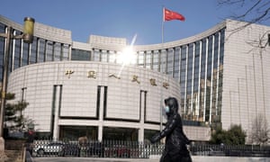 Coronavirus live news: record daily cases in South Africa as India extends lockdown 9 A woman wearing a mask walks past the headquarters of the People’s Bank of China, the central bank, in Beijing, China.