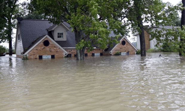 A home is surrounded by floodwaters from Hurricane Harvey in Spring, Texas.