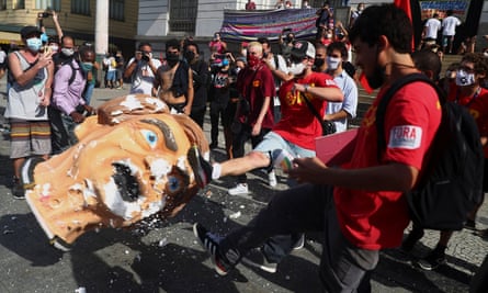Demonstrators kick a head prop depicting Brazil’s president,Jair Bolsonaro, during a protest in Rio de Janeiro on Saturday.