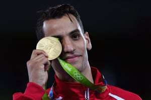 Ahmad Abughaush celebrates on the podium after the men’s -68kg gold medal Taekwondo contest.