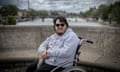 Cedric Alvarez in a wheelchair with Paris in background