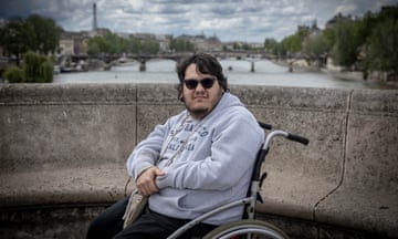 Cedric Alvarez in a wheelchair with Paris in background