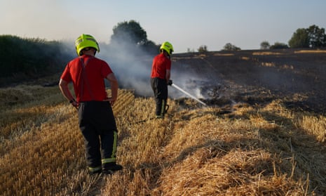 Firefighters tackle a crop fire in Skelton, England