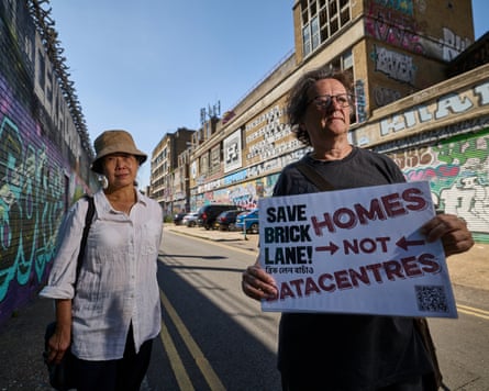Moberley and Kow on a street holding a sign that reads ‘save Brick Lane, homes not datacentres’