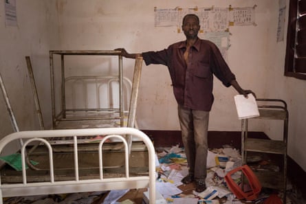 Hospital lab technician Leon Bambeteba stands amid rubbish at a hospital that was looted during an attack on Gambo in which dozens of civilians were killed