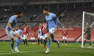 John Stones, right, celebrates scoring the opening goal of Manchester City’s Carabao Cup semi-final victory over Manchester United.