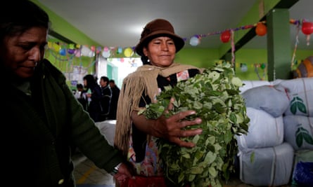 A coca grower holds coca leaves at a market in La Paz, Bolivia.