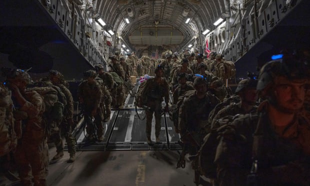 US troops disembark in Kuwait on Tuesday as the last American soldiers leave Afghanistan.
