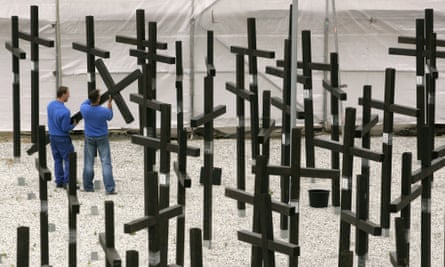 Workers take down the crosses of the Mauermuseum’s memorial to those who died because of the wall.