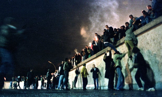 A crowd on top of the Berlin wall in 1989