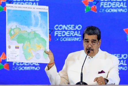 Venezuela’s president Nicolas Maduro holding up a map of the disputed territory in Guyana he is claiming for Venezuela.