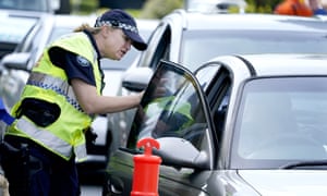 A police officer talks to a driver at a checkpoint at Coolangatta on the Queensland-New South Wales border