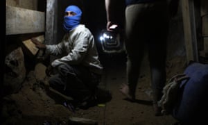 A Palestinian youth works inside a smuggling tunnel beneath the Egyptian-Gaza border in 2013. Most of these tunnels have since been destroyed by the Egyptian army.
