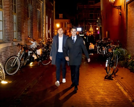 Leader of the Democrats 66 (D66) party Rob Jetten (R) arrives with his husband, Nicolas Keenan, (L) to his party results evening during the Dutch parliamentary elections, in Leiden.
