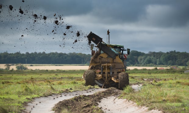 A ditcher is used to create waterways for migrating birds on the Holkham estate, Norfolk.