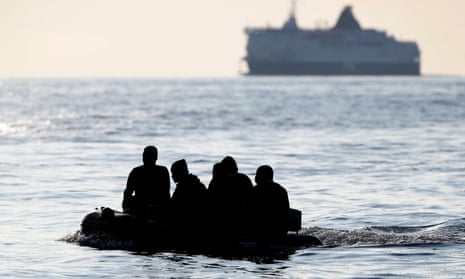 People claiming to be from Darfur, Sudan, cross the Channel in an inflatable boat near Dover on Wednesday