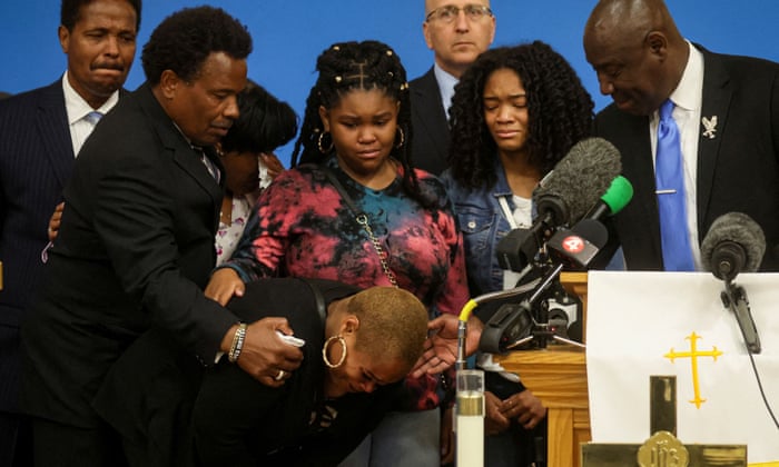 Ben Crump (right) comforts family members of Buffalo victim Ruth Whitfield at a press briefing on Monday.