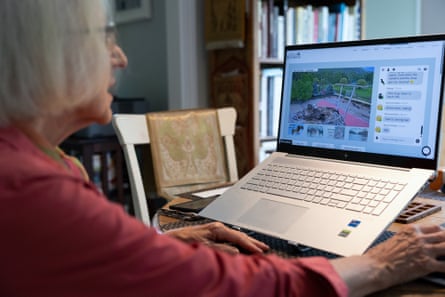 An older woman sits in front of a laptop.
