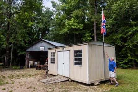 Ira Isonhood adjusts the flag pole in the backyard of his home in Copiah County, Mississippi.