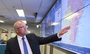 Scott Morrison looks at a screen