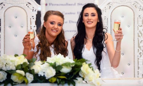 Robyn Peoples (left) and Sharni Edwards make a toast during their wedding in Loughshore hotel in Carrickfergus.