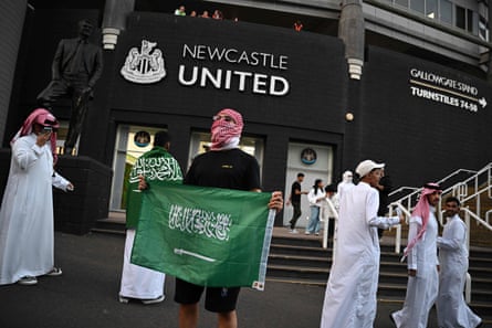 Saudi football fans pose with flags before their team’s international friendly with Costa Rica at St James’ Park.