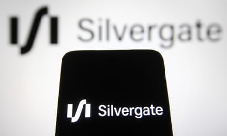 Silvergate logo is seen displayed on a smartphone and a computer screen.