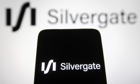 Silvergate Capital Corporation logo is seen displayed on a smartphone and a pc screen