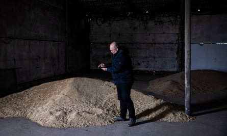 Eugene Babalik examines grain in a warehouse on his farm in Odesa oblast.