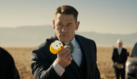 A man in a suit holding an animated Tweety Pie bird