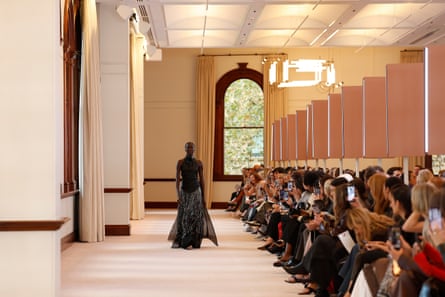 A model walks the runway in a grand interior