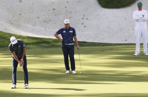 Sungjae Im watches as Dustin Johnson sinks his birdie putt on the thirteenth hole
