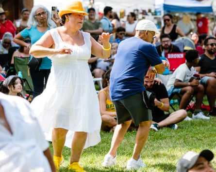 people dance on a sunny day in the grass
