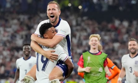 Kane leaps into Watkins’ arms after the final whistle