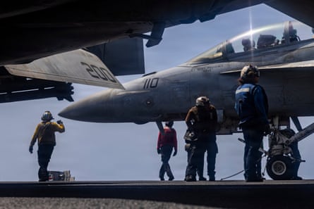 US sailors preparing to taxi an F/A-18F Super Hornet on the flight deck of the aircraft carrier USS Abraham Lincoln last week