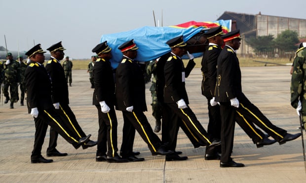 Guards of honour carry a coffin containing a tooth of Patrice Lumumba