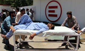 A man is transported to hospital after the car bomb attack in Lashkar Gah, Afghanistan