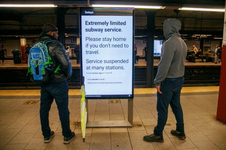 Straphangers stand near a digital sign warning travelers about the weather affecting subway service in New York, New York, USA, 29 September 2023.