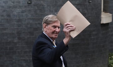 Bill Cash holds up a manila folder