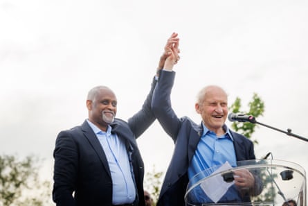 Boutrin and Guillon de Princé clasp hands in the air
