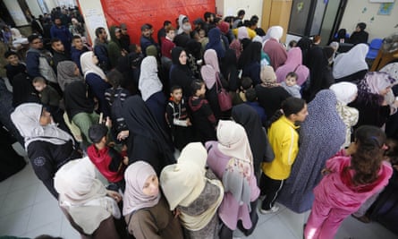 Palestinian patients gather at a health centre run by the UN relief and works agency (UNRWA) to receive medicines.