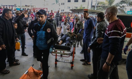 A person injured in Israeli airstrikes arrives to be treated at Nasser hospital in Khan Younis, southern Gaza.