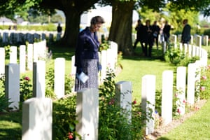 Princess Anne looks upon the white stone war graves at Bayeux cemetery in France