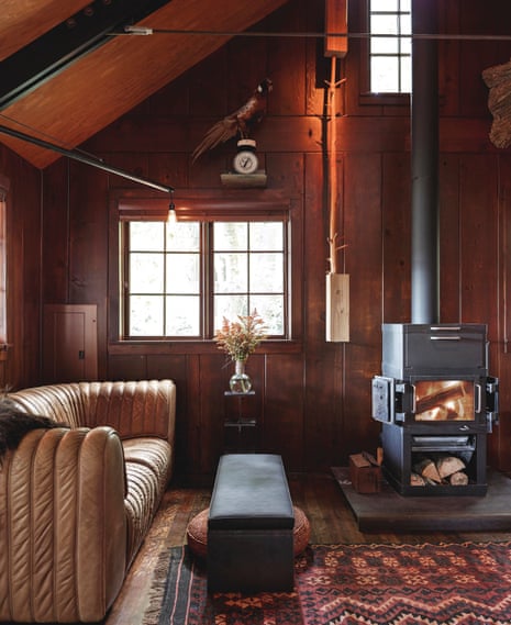 An attic was removed to give the cabin its 17ft-high ceiling. The stove and sofa are both from the 1970s.