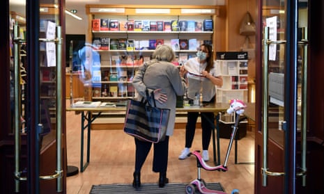 ‘Lire, c’est vivre’ … a woman collects an order at a bookshop in Neuilly-sure-Seine, France, in April.