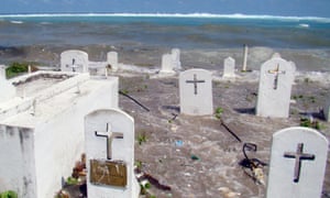 This 2008 photo shows a cemetery on the shoreline in Majuro Atoll being flooded from high tides and ocean surges in the low-lying Marshall Islands.